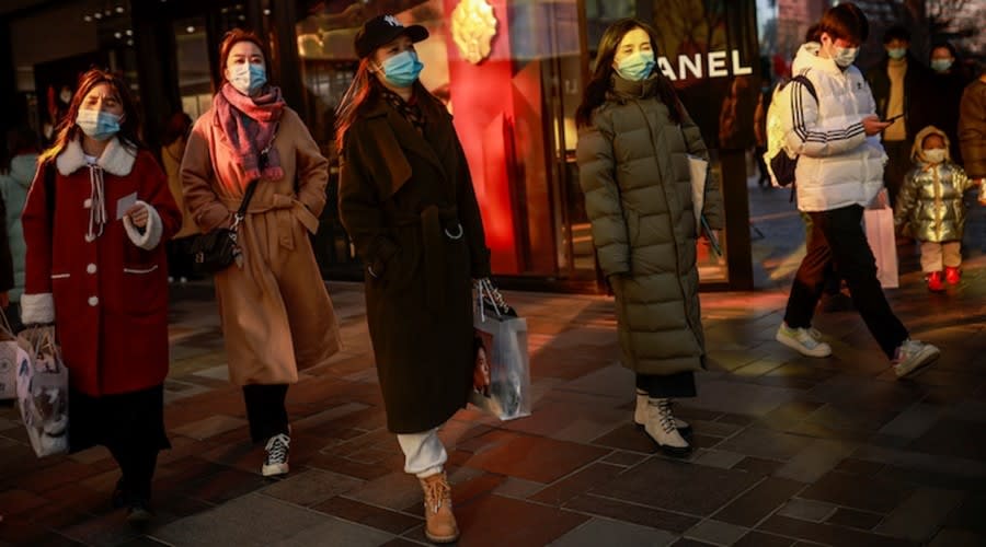 FILE PHOTO: People walk past a Chanel store in a shopping district during Lunar