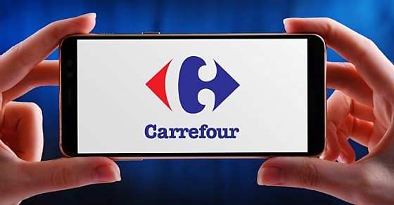 POZNAN, POL - MAY 21, 2020: Hands holding smartphone displaying logo of Carrefou