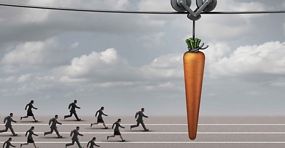 Employee incentive business concept as a group of businessmen and businesswomen running on a track towards a dangling carrot on a moving cable as a financial reward metaphor to motivate for a goal.